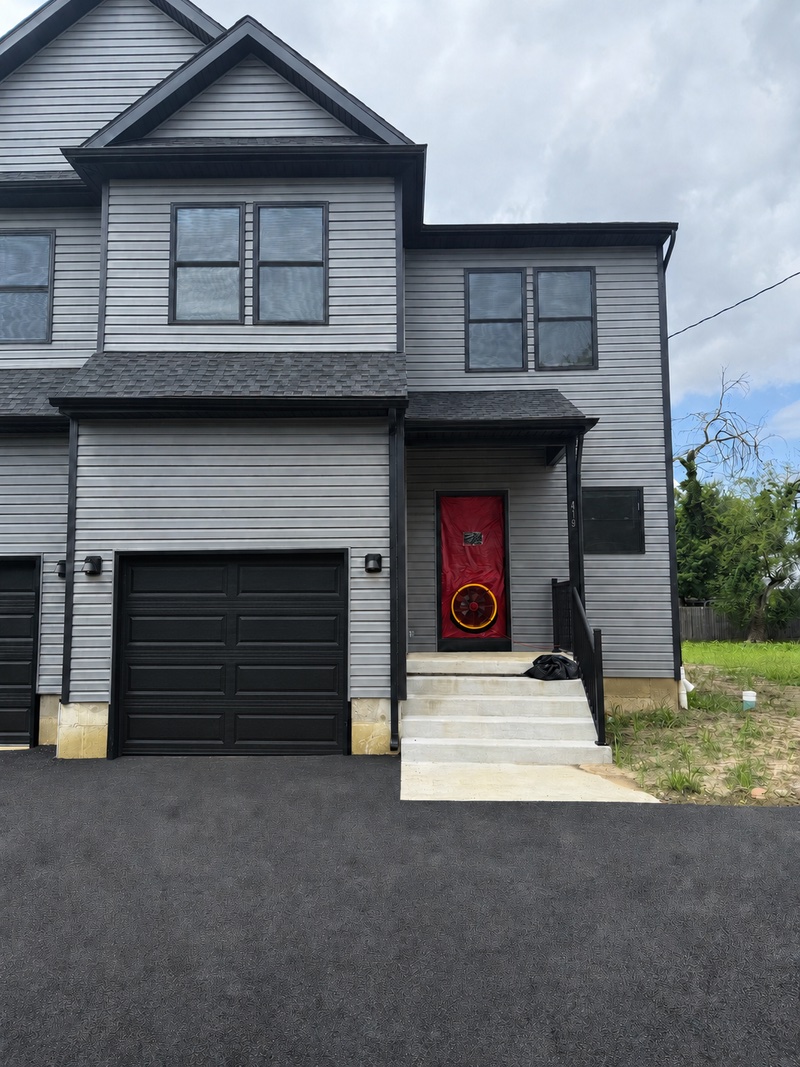 Blower door testing equipment installed in the entrance of a newly constructed home.
